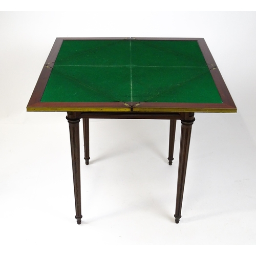 1809 - A 19thC mahogany envelope card table with two frieze drawers raised on four turned tapering and reed... 