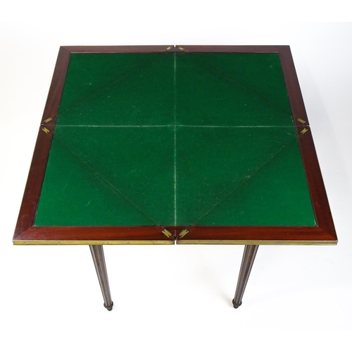 1809 - A 19thC mahogany envelope card table with two frieze drawers raised on four turned tapering and reed... 