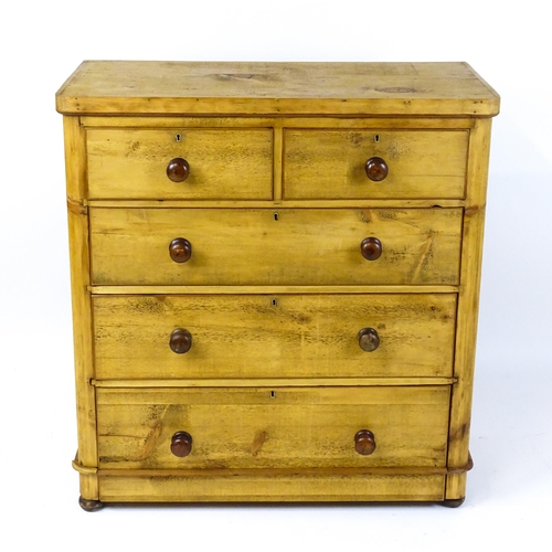 1810 - A late Victorian pine chest of drawers comprising two short over three long graduated drawers with t... 