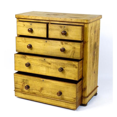 1810 - A late Victorian pine chest of drawers comprising two short over three long graduated drawers with t... 