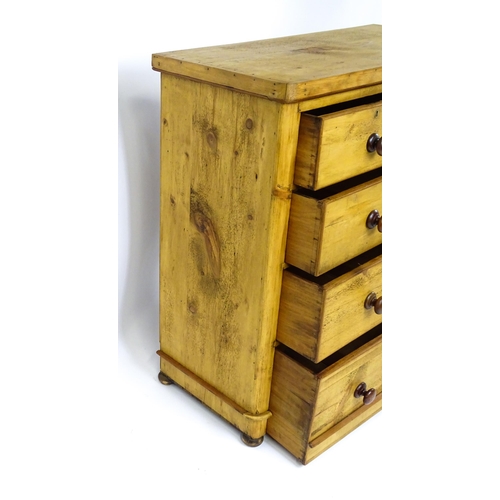 1810 - A late Victorian pine chest of drawers comprising two short over three long graduated drawers with t... 