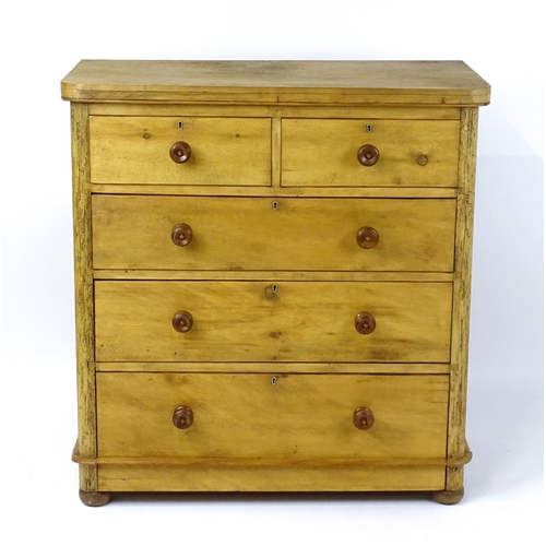 1811 - A late Victorian pine chest of drawers comprising two short over three long graduated drawers with t... 