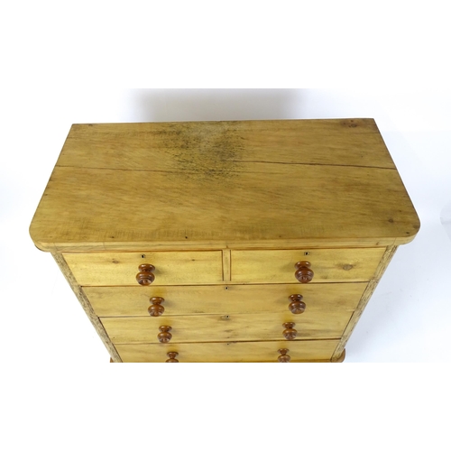 1811 - A late Victorian pine chest of drawers comprising two short over three long graduated drawers with t... 