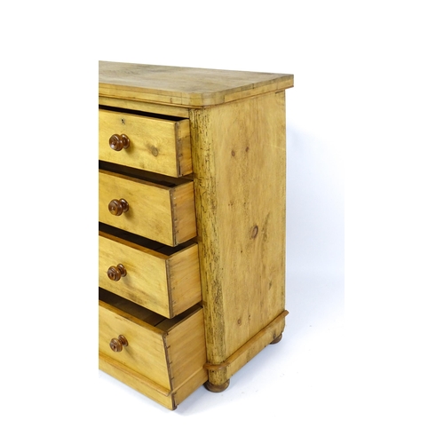 1811 - A late Victorian pine chest of drawers comprising two short over three long graduated drawers with t... 