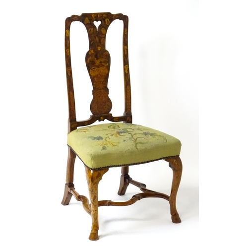 1812 - An early / mid 18thC Dutch side chair with a profusely inlaid walnut frame, the satinwood marquetry ... 