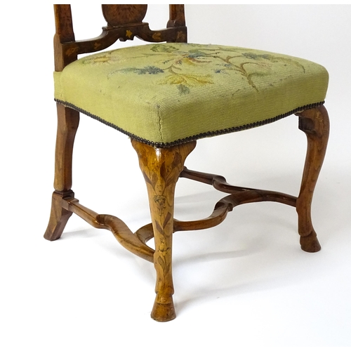 1812 - An early / mid 18thC Dutch side chair with a profusely inlaid walnut frame, the satinwood marquetry ... 