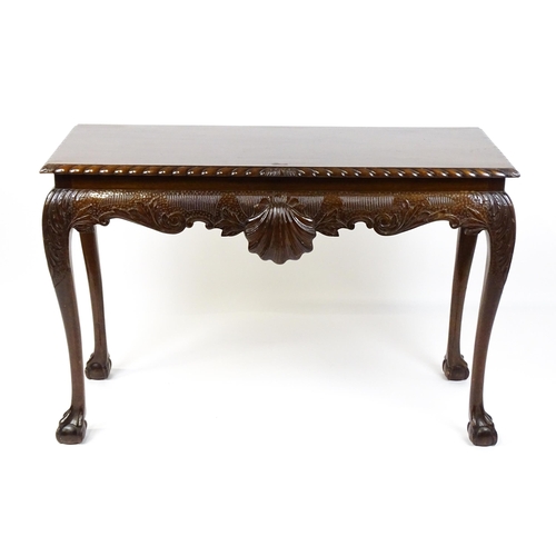 1819 - An antique Irish console table with a gadrooned top edge above a floral and shell carved apron raise... 