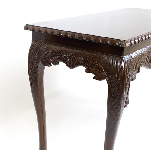 1819 - An antique Irish console table with a gadrooned top edge above a floral and shell carved apron raise... 