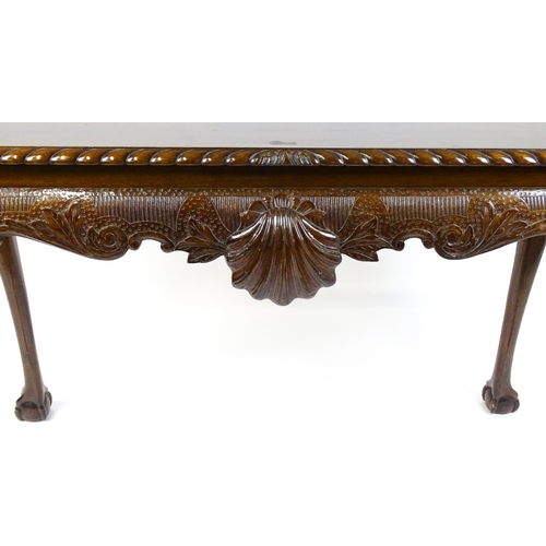 1819 - An antique Irish console table with a gadrooned top edge above a floral and shell carved apron raise... 