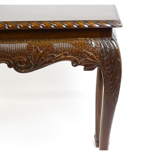 1819 - An antique Irish console table with a gadrooned top edge above a floral and shell carved apron raise... 