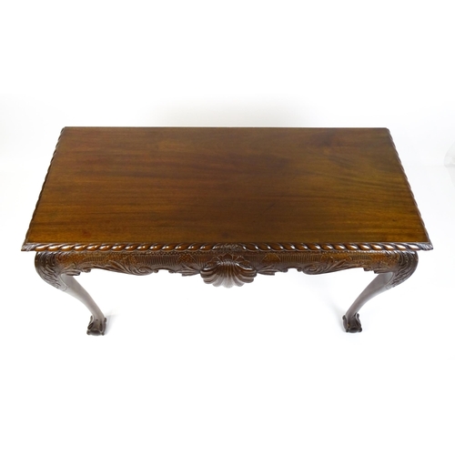 1819 - An antique Irish console table with a gadrooned top edge above a floral and shell carved apron raise... 