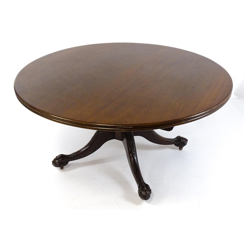 1821 - A large early 19thC Irish dining / breakfast table with a large circular top above a turned pedestal... 