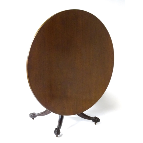 1821 - A large early 19thC Irish dining / breakfast table with a large circular top above a turned pedestal... 