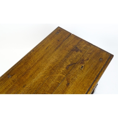 1822 - An 18thC oak side table with a planked top above a single frieze drawer raised on four block and tur... 