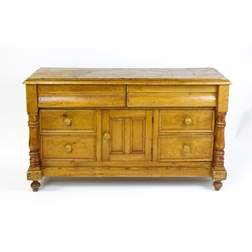 1823 - A Victorian pine dresser with a moulded top above two frieze drawers and a panelled cupboard flanked... 