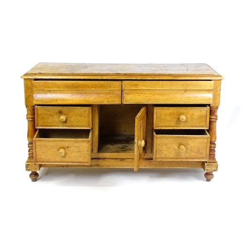 1823 - A Victorian pine dresser with a moulded top above two frieze drawers and a panelled cupboard flanked... 