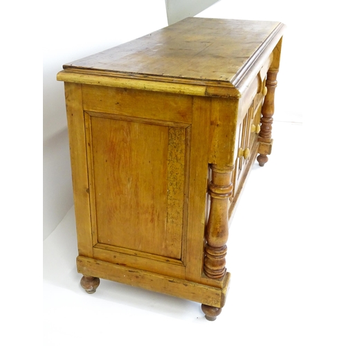 1823 - A Victorian pine dresser with a moulded top above two frieze drawers and a panelled cupboard flanked... 