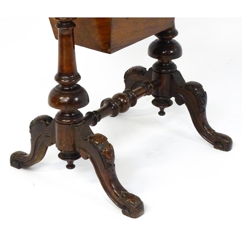 1827 - A Victorian walnut sewing table with satinwood decorative inlay, the lid opening to show fitted comp... 