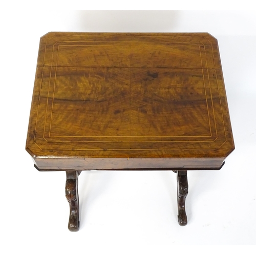 1827 - A Victorian walnut sewing table with satinwood decorative inlay, the lid opening to show fitted comp... 