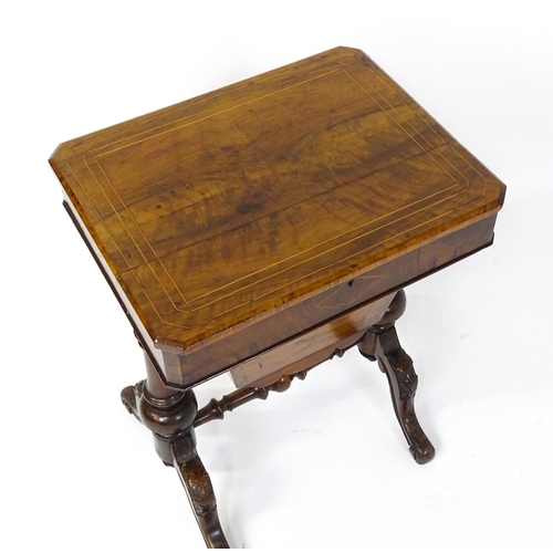 1827 - A Victorian walnut sewing table with satinwood decorative inlay, the lid opening to show fitted comp... 