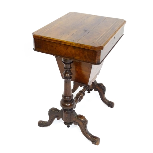 1827 - A Victorian walnut sewing table with satinwood decorative inlay, the lid opening to show fitted comp... 