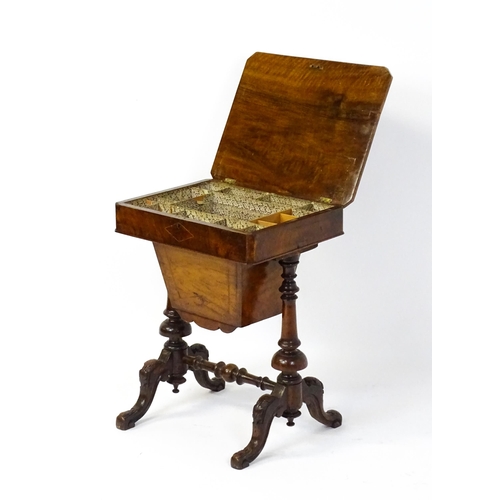 1827 - A Victorian walnut sewing table with satinwood decorative inlay, the lid opening to show fitted comp... 