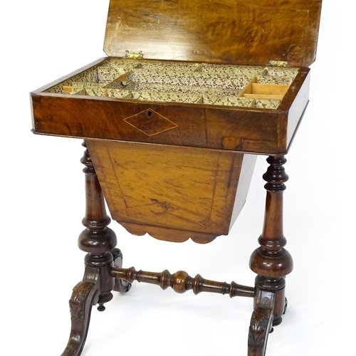 1827 - A Victorian walnut sewing table with satinwood decorative inlay, the lid opening to show fitted comp... 