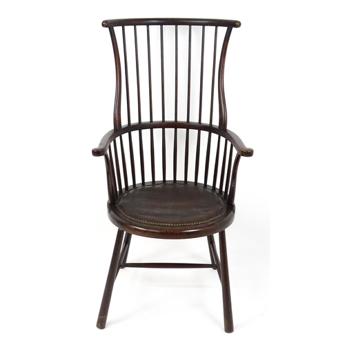 1829 - An Arts & Crafts c. 1900 Windsor chair in the manner of Liberty & Co. The chair having a bowed stick... 