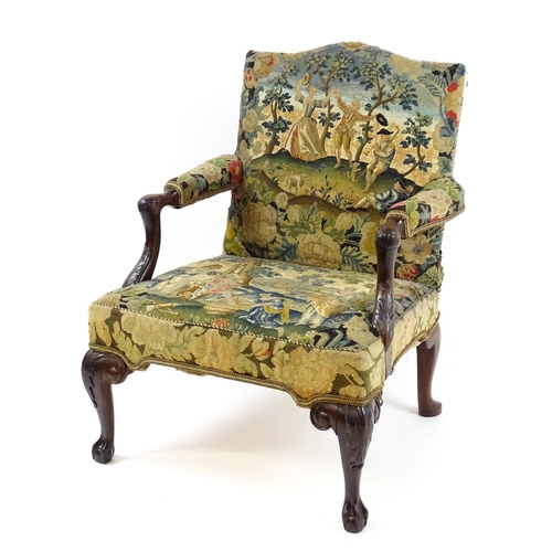 1834 - An 18thC Irish Gainsborough chair with needlework tapestry upholstery and acanthus carved arms raise... 