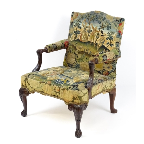 1834 - An 18thC Irish Gainsborough chair with needlework tapestry upholstery and acanthus carved arms raise... 