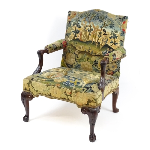 1834 - An 18thC Irish Gainsborough chair with needlework tapestry upholstery and acanthus carved arms raise... 