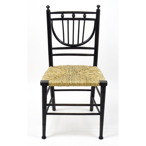 1840 - An Arts & Crafts Morris & Co designed Sussex chair with an envelope seat raised on ring turned taper... 