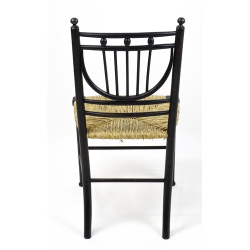 1840 - An Arts & Crafts Morris & Co designed Sussex chair with an envelope seat raised on ring turned taper... 