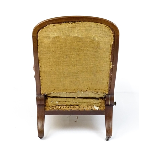 1841 - A William IV mahogany reclining armchair with leather upholstered armrests and raised on turned tape... 