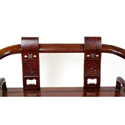 1842 - An early 20thC Chinese elm bench with scrolled arms,, carved pierced back rests  and raised on four ... 