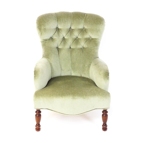 1852 - A late 20thC button back armchair raised on turned tapering front legs. 24