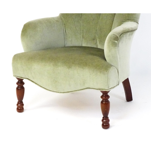 1852 - A late 20thC button back armchair raised on turned tapering front legs. 24