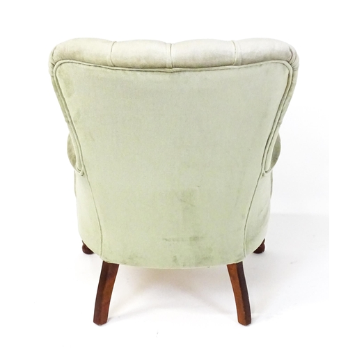 1852 - A late 20thC button back armchair raised on turned tapering front legs. 24