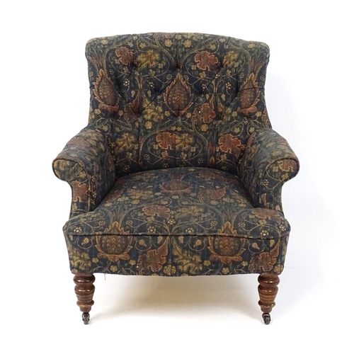 1856 - A late 19thC nursing chair with a deep buttoned backrest, scrolled armrests, sprung seat and raised ... 