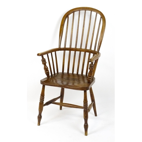 1857 - A mid 19thC double bow back Windsor chair with a shaped seat raised on four turned tapering legs uni... 