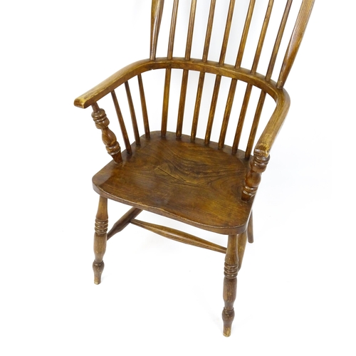 1857 - A mid 19thC double bow back Windsor chair with a shaped seat raised on four turned tapering legs uni... 