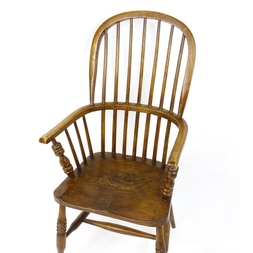 1857 - A mid 19thC double bow back Windsor chair with a shaped seat raised on four turned tapering legs uni... 