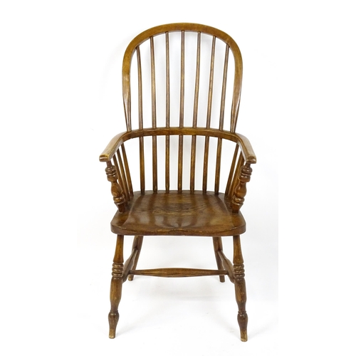 1857 - A mid 19thC double bow back Windsor chair with a shaped seat raised on four turned tapering legs uni... 