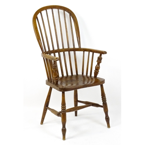 1857 - A mid 19thC double bow back Windsor chair with a shaped seat raised on four turned tapering legs uni... 