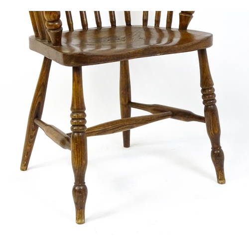 1857 - A mid 19thC double bow back Windsor chair with a shaped seat raised on four turned tapering legs uni... 