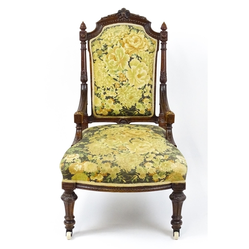 1859 - A 19thC walnut nursing chair surmounted by turned finials and having fluted supports with acanthus c... 