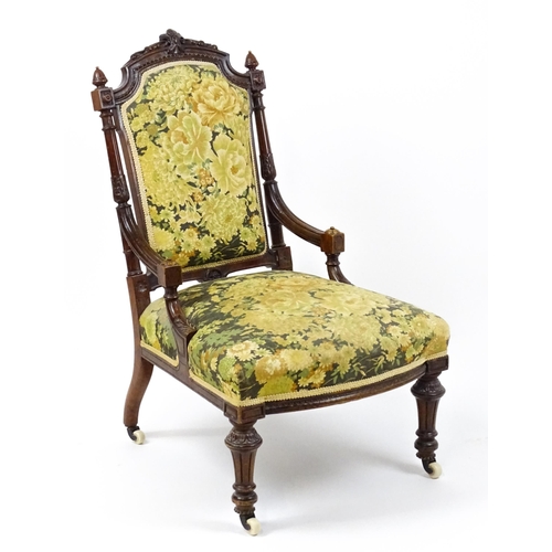 1859 - A 19thC walnut nursing chair surmounted by turned finials and having fluted supports with acanthus c... 