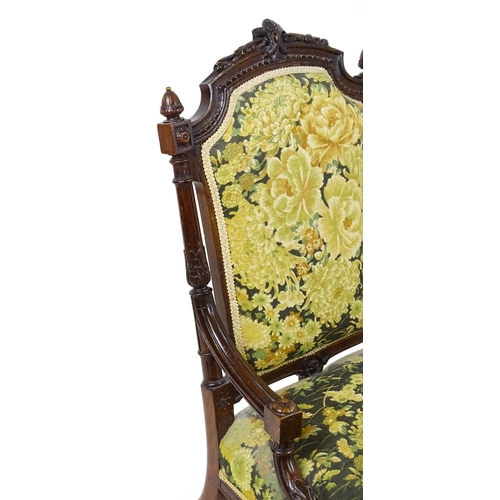 1859 - A 19thC walnut nursing chair surmounted by turned finials and having fluted supports with acanthus c... 