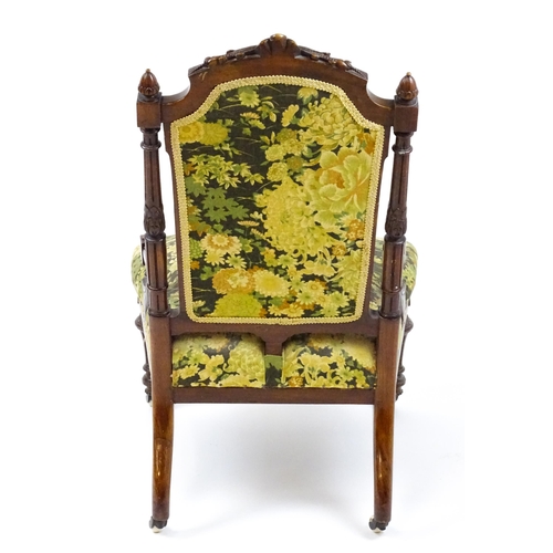 1859 - A 19thC walnut nursing chair surmounted by turned finials and having fluted supports with acanthus c... 