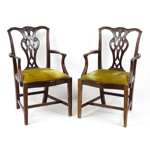 1861 - A pair of late 19thC Chippendale style open armchairs, with pierced and carved back splats above spl... 